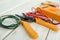 Wire stripper and wire on wooden table, closeup. Electrical tools