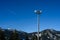 Wireless cell site with antenna mounted on towers in a winter mountain landscape on a sunny day.