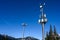 Wireless cell site with antenna mounted on towers in a winter mountain landscape on a sunny day.