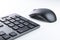 Wireless gray keyboard and mouse on a white background close-up.