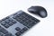 Wireless gray keyboard and mouse on a white background close-up.