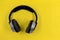 Wireless headphones on yellow background, photo directly above