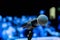 Wireless microphone on the stand. Blurred background. People in the audience. Show on stage in the theater or concert hall