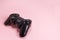Wireless modern joystick gamepad on pink background, video game concept. Copyspace for text