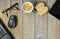 Wireless mouse, optical eyeglasses, a cup of coffee, piece of bread and tablet on a wooden surface