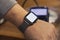 Wireless online payment. A mockup of a smart watch with a white screen on a man& x27;s hand against the background of terminal for