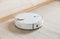 Wireless robot vacuum cleaner working on the floor. Smart household technologies