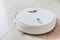 Wireless robot vacuum cleaner working on the floor. Smart household technologies