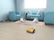 Wireless robotic vacuum cleaner in a pastel blue color interior