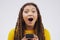 The wireless world is filled with surprised. Studio shot of a young woman looking surprised while reading something on