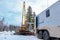 Wireline equipment hanging from top drive ready to be lowered downhole for logging. An oil well engineer works from the