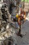 Wireline equipment hanging from top drive ready to be lowered downhole for logging. An oil well engineer works from the back of