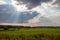 Wisconsin farmland with sunrays coming out of the clouds in September