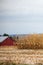 Wisconsin red barn with a little snow in the cornfield in autumn