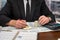 wise male businessman working with important documents at office desk.