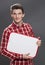 Wise young male student or intern holding a copy space banner