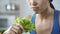 Wishing lose weight and be slim, lady making herself eating lettuce, nutrition