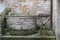 Wishing well against city wall in Cittadella, Italy