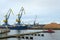 WISMAR, GERMANY, FEBRUARY 2, 2020: Crane boat, fire brigade ship and a wood processing factory  in the timber port of Wismar in