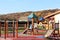 Wisniowa, Poland - oct 12 2018: Children`s playground in the park amidst greenery. Multicolored swings and buildings for children