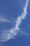 Wispy cloud on blue sky background