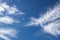 Wispy cloud design against a blue sky