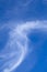 Wispy white Cirrus cloud against blue sky