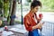 Wistful ethnic woman reading message on phone