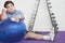 Wistful Overweight Man On Floor With Exercise Ball