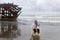 Wistful Woman On Beach With Shipwreck