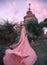 Witch elf rises to the castle, princess with blond hair, oblique and tiara dresses pink dress and cloak with a long