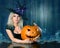 Witch with Halloween pumpkin. Beautiful girl