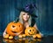 Witch with Halloween Pumpkins. Happy Beautiful Blond