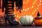 Witch legs in striped stockings and high heel shoes with pumpkins on an orange background, bokeh. Halloween. Copy space