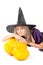 Witch sitting beside pumpkins