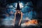 Witch with spooky Jack O Lantern pumpkins and misty forest under moon on Halloween
