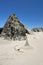 â€œWitches Hatâ€ Sand Castle In Front Of Rock On Beach