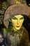 Witchy Halloween Decoration - Detail of beautiful earth witch in brown costume and hat with very green eyes - selective focus