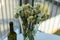 Withered yellow roses and wine bottle