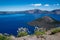 Wizard Island view of Crater Lake National Park in Oregon in summer. Wildflowers in foreground