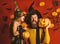 Wizard and little witch in black hats hold pumpkins.