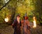 Wizard and sorceress in the autumn forest. Elderly man and woman in carnival costumes for halloween