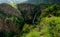 Wli waterfall surrounded by lush green tropical forest