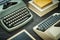 Wo old typewriters and a book on a black table