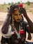 Wodaabe man checking makeup in a mirror, Gerewol, Niger