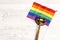 Woden judge gavel symbol of law and justice with lgbt flag in rainbow colours on wooden background