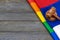 Woden judge mallet symbol of law and justice with lgbt flag in rainbow colours on wooden background