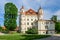 Wojanow Palace, an impressive building in the English neo-Gothic style. The facility is located by the Bobr River