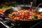wok on stove with colorful stir-fried vegetables