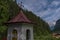 Wolfaukapelle chapel in sunny cloudy morning in Austria mountains